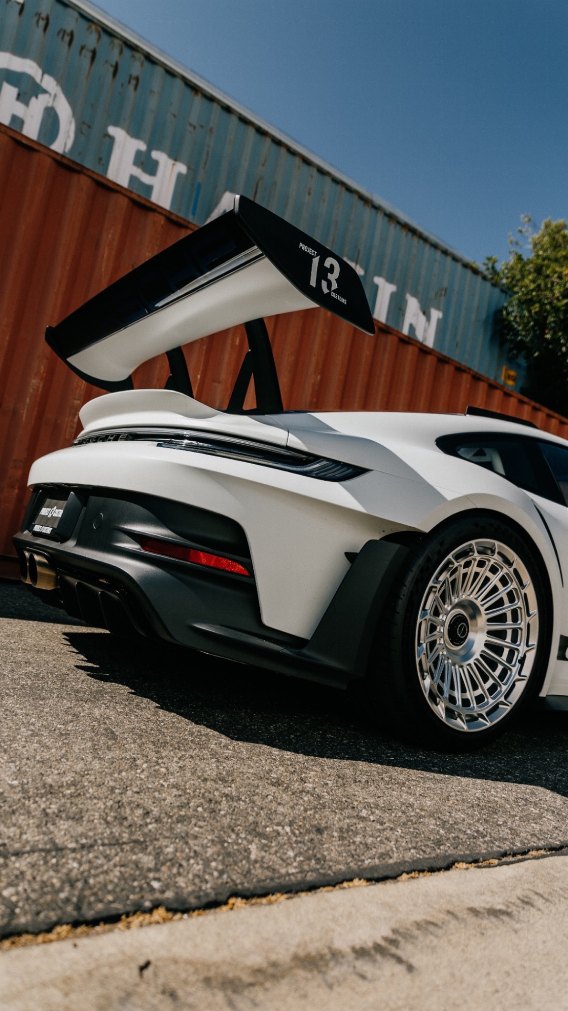 Rear wing and silver wheel on a white Porsche GT3 RS