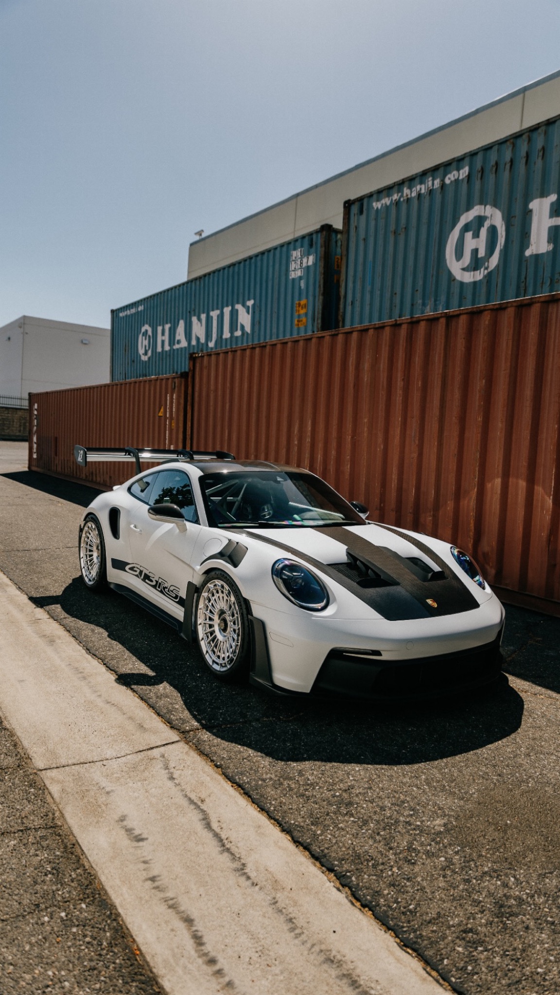 White Porsche GT3 RS with silver wheels photographed outdoors